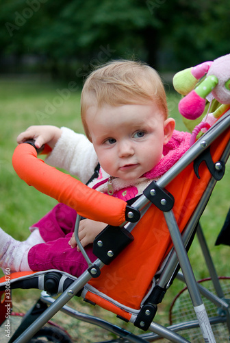 1 year old girl sitting in baby carriage