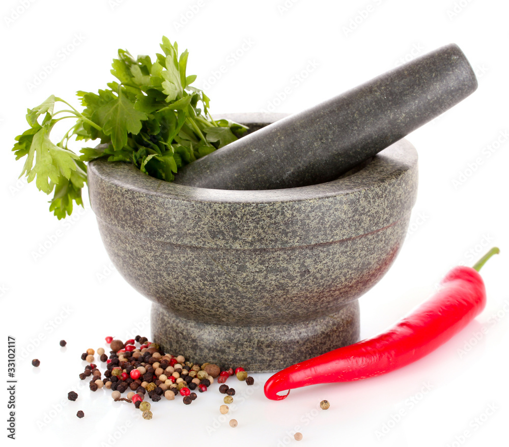 Mortar and pestle, parsley and pepper isolated on white