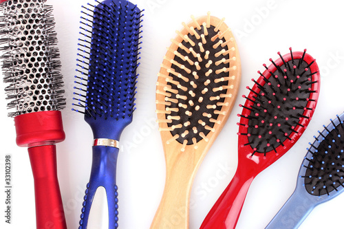 Different types of hairbrushes isolated on white