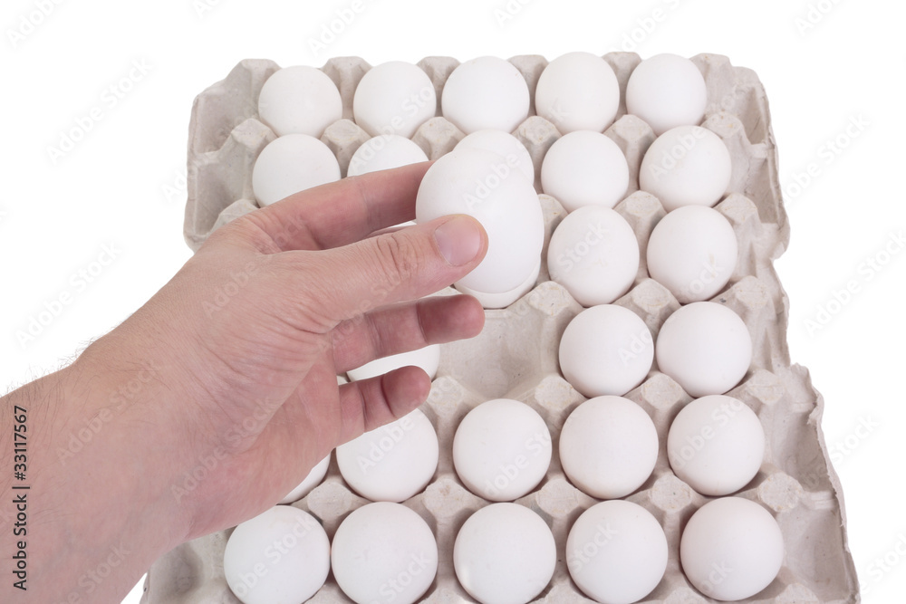 The concept of a correct choice. Hand of man chooses one egg out The concept of a correct choice. Hand of man chooses one egg out