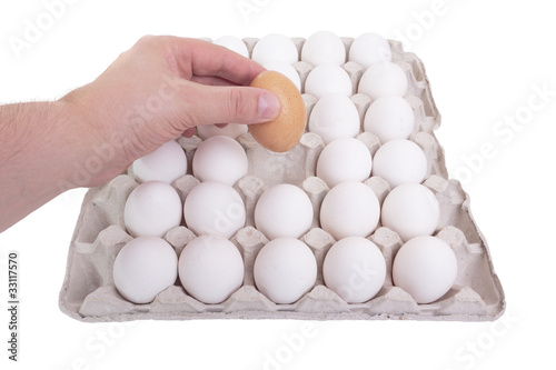 The concept of a correct choice. Hand of man chooses one egg out
