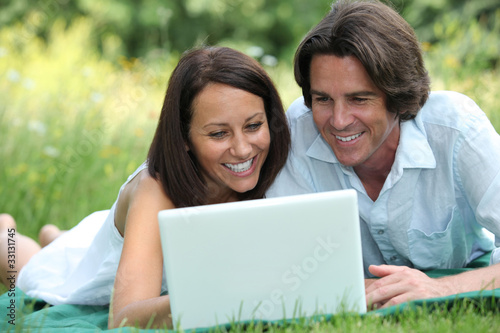 couple in front of a laptop