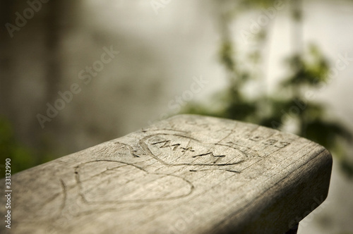 Wooden engraving on the handrail of a bench