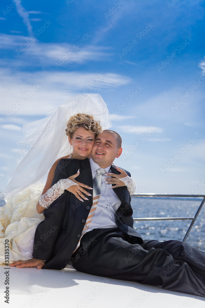 Happy bride and groom on a luxury yacht