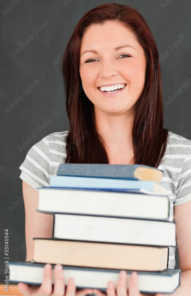 Laughing young woman bringing books Laughing young woman bringing books