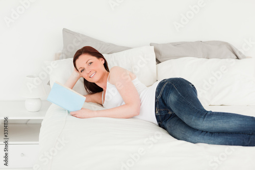 Pretty woman posing with a book