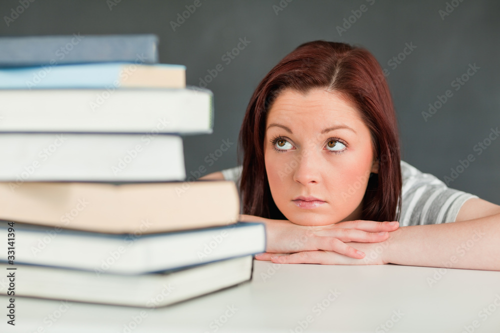 Desperate student looking at her books Desperate student looking at her books