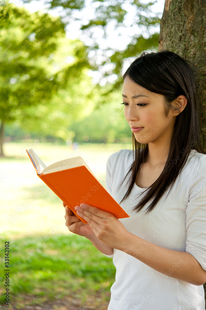 beautiful asian woman reading a book in the park beautiful asian woman reading a book in the park
