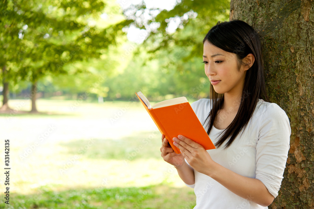 beautiful asian woman reading a book in the park beautiful asian woman reading a book in the park