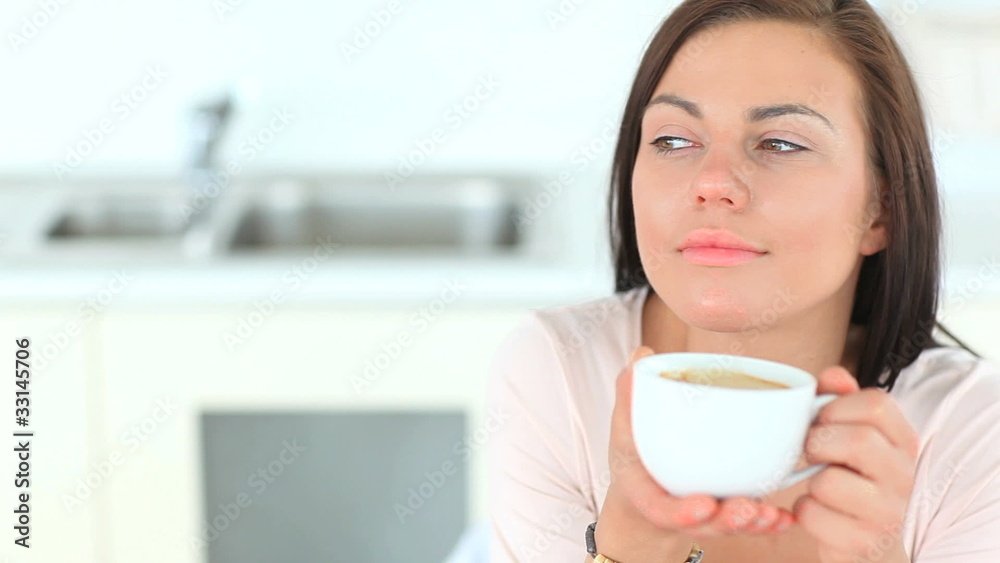 Beautiful brunette woman enjoying a cup of coffee Beautiful brunette woman enjoying a cup of coffee