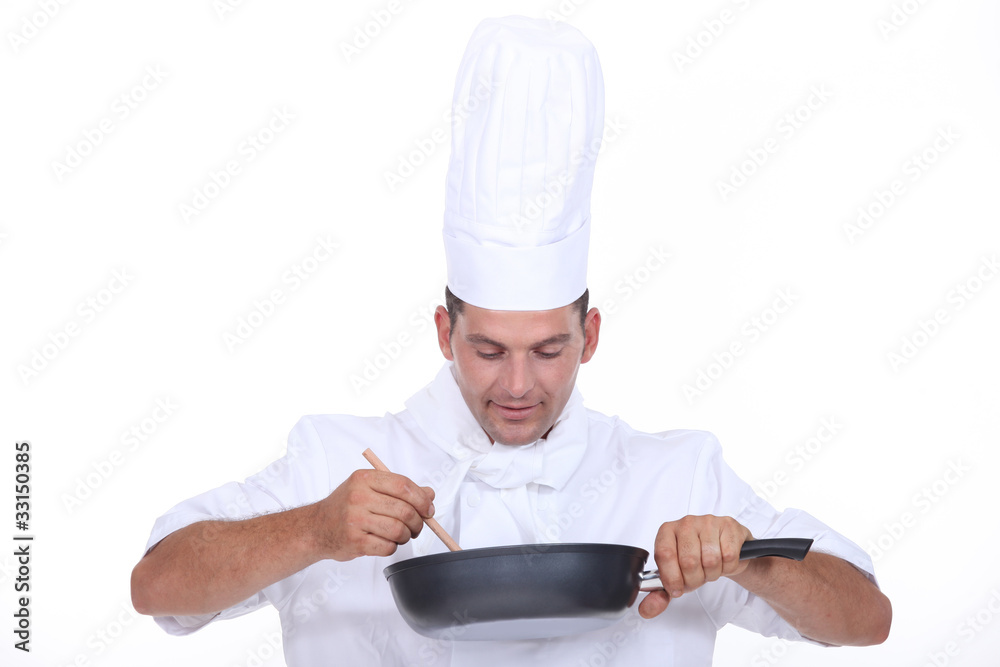 Chef stirring contents of saucepan Chef stirring contents of saucepan