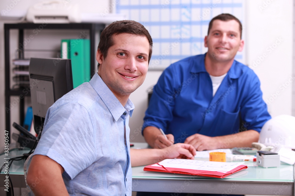 © auremar - two male colleagues sat in an office © auremar - two male colleagues sat in an office