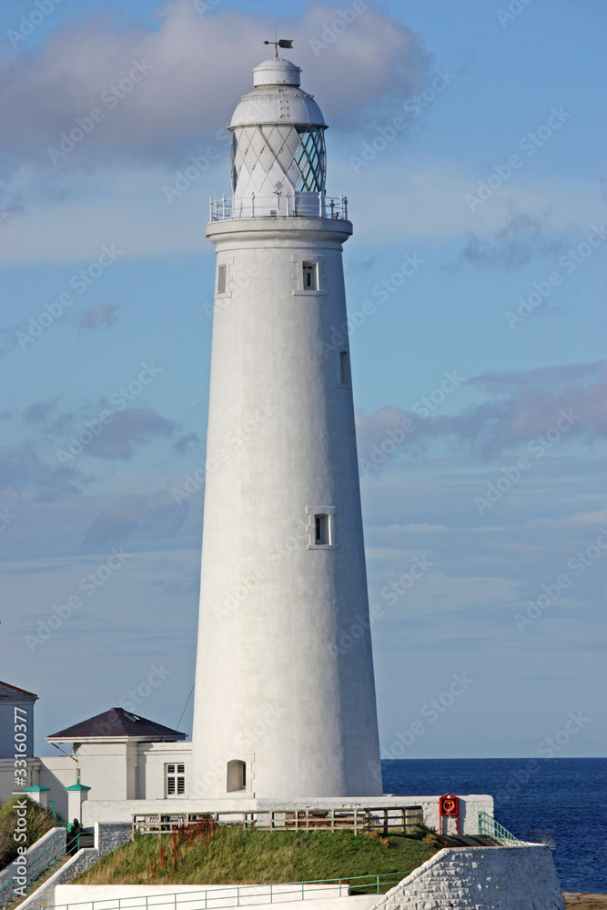A Traditional Tall British Coastal White Lighthouse.