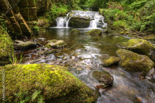 Stunning waterfall flowing over rocks through lush green forest