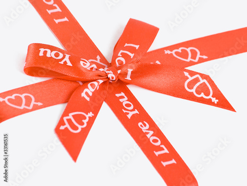 Red gift bow with hearts.
