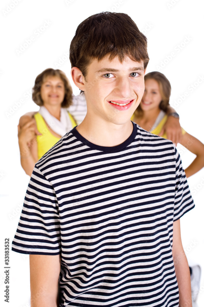 Smiling young kid in focus with family in the background Smiling young kid in focus with family in the background
