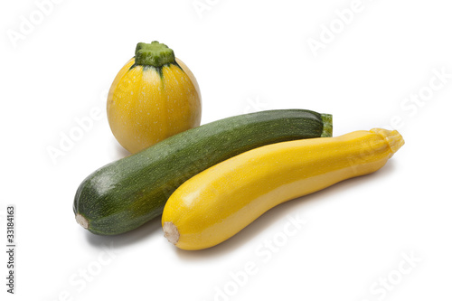 Bild auf Leinwand Yellow, green and round courgette