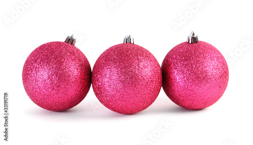 Three red Christmas tree balls lies in the range isolated