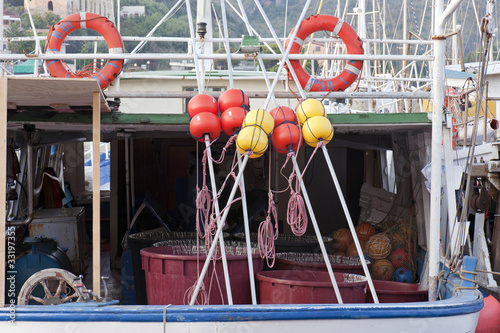 Buckets with hooks on the stern of a fishing boat © Tony