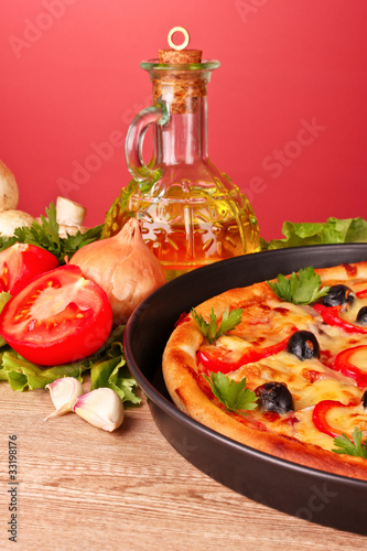 pizza and vegetables on a red background