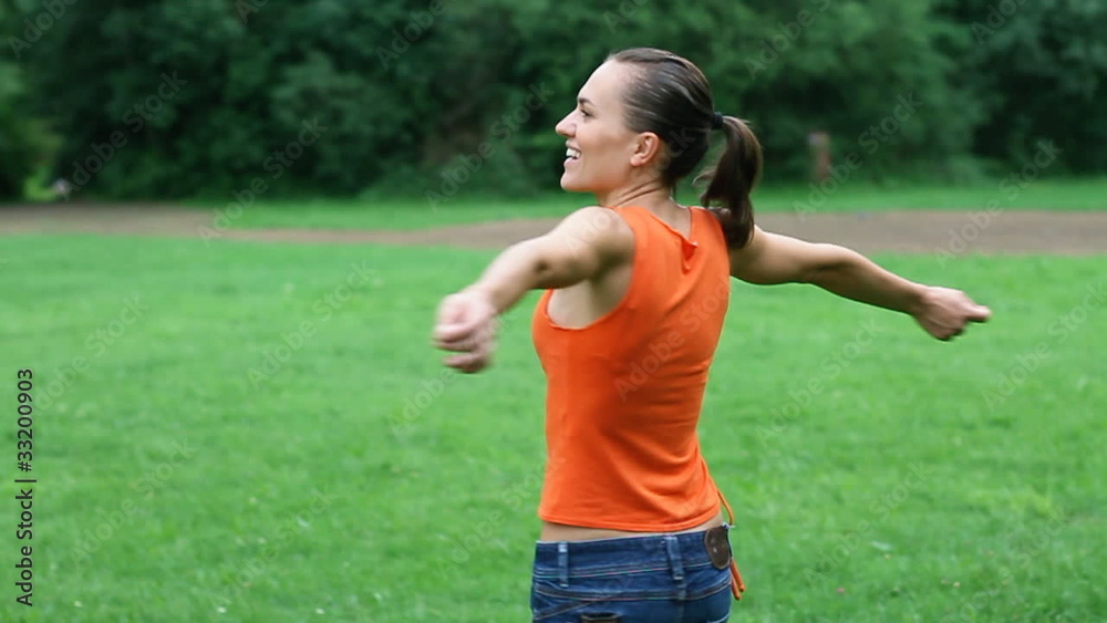 Happy woman turning around on meadow, slow motion, steadicam Happy woman turning around on meadow, slow motion, steadicam