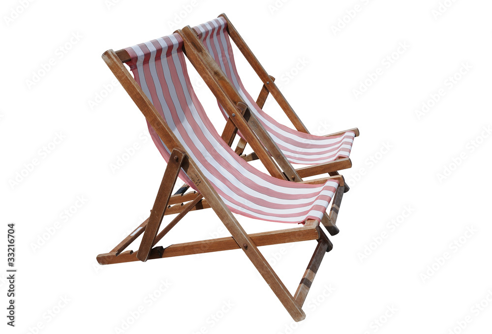 Two red and white striped deckchairs, isolated on white