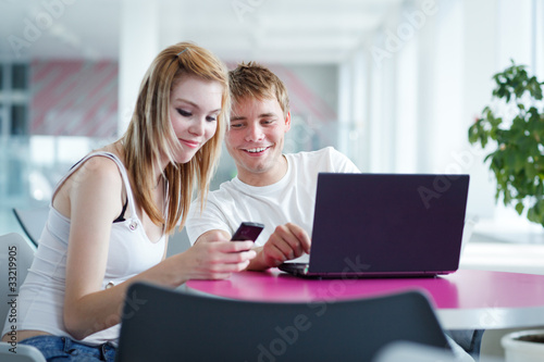 two college students having fun studying together © lightpoet