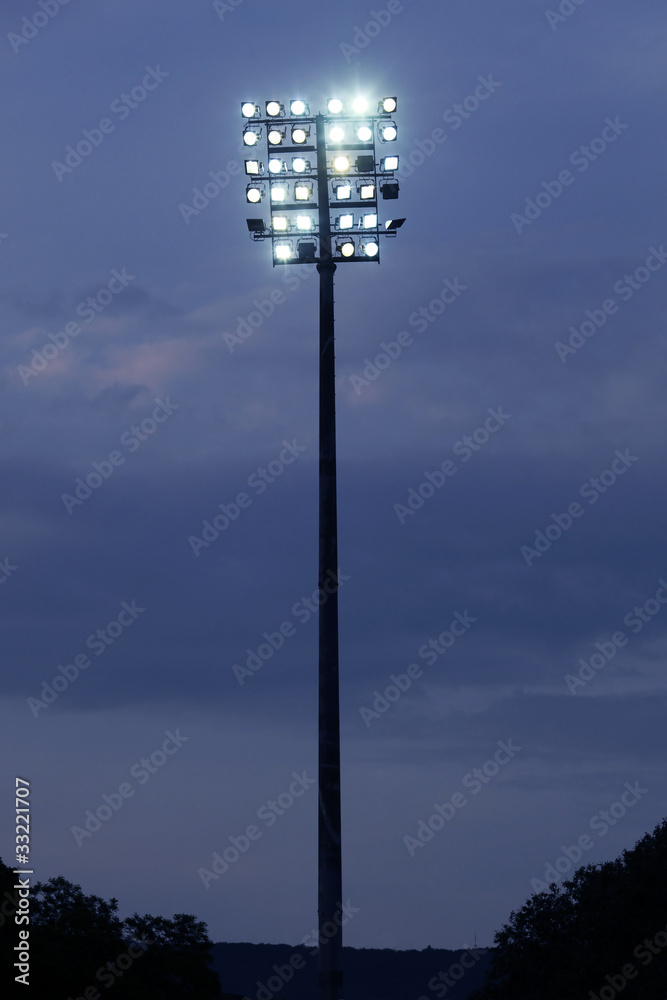 Stadium lights on a sports field at evening