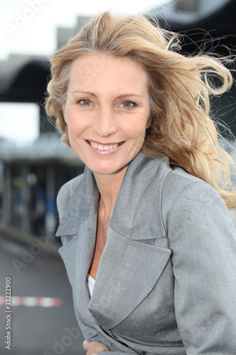 Businesswoman smiling with wind in hair Free Download Businesswoman smiling with wind in hair - GFXLoad