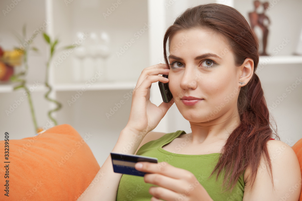 woman on phone with credit card