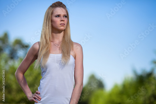 Beautiful young blonde woman in park