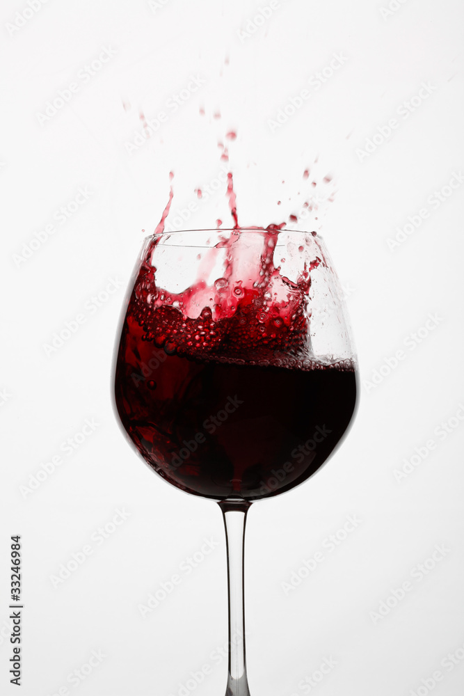 glass of red wine splashing glass of red wine splashing