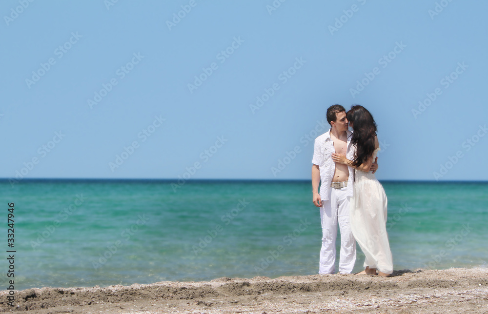 young loving couple on sea background