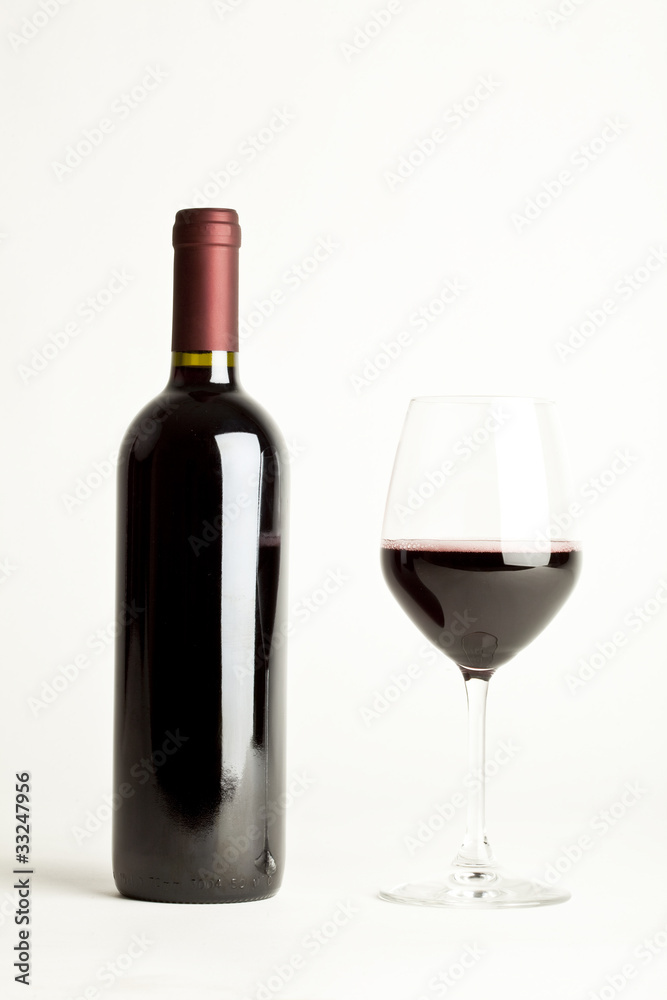 Glass of red wine and a bottle isolated over white background Glass of red wine and a bottle isolated over white background
