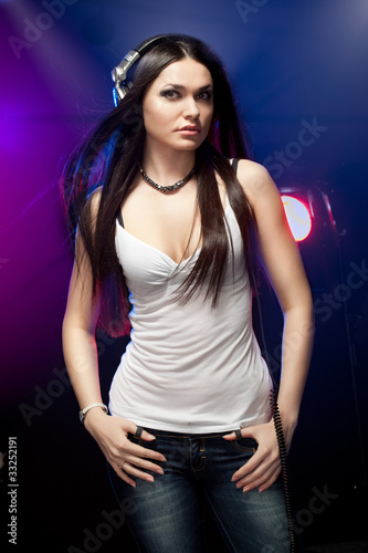 beautiful woman dj wearing headphones