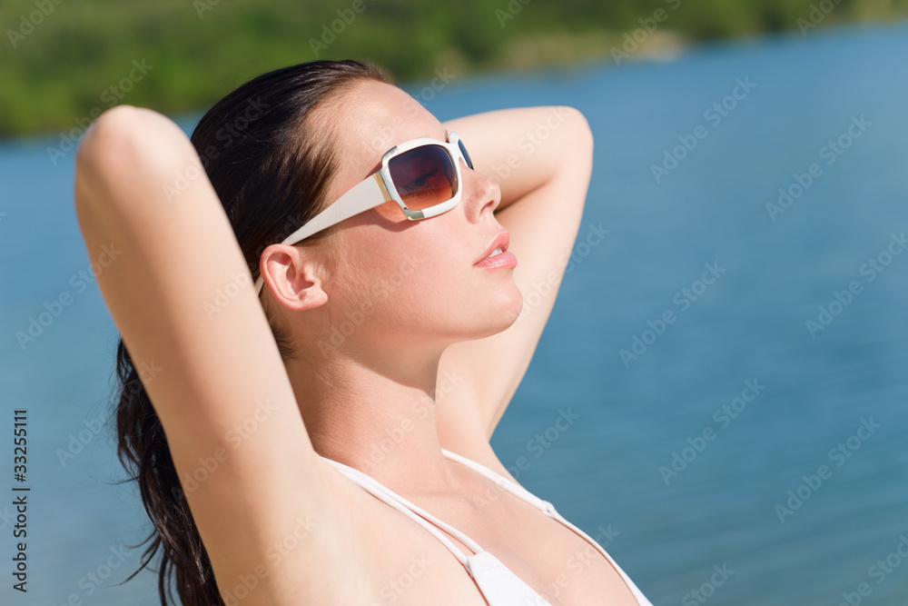 Young sexy bikini model relaxing with sunglasses Young sexy bikini model relaxing with sunglasses