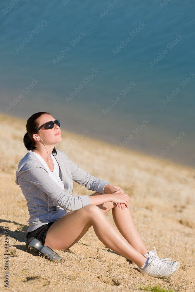 Summer sport fit woman relax on beach