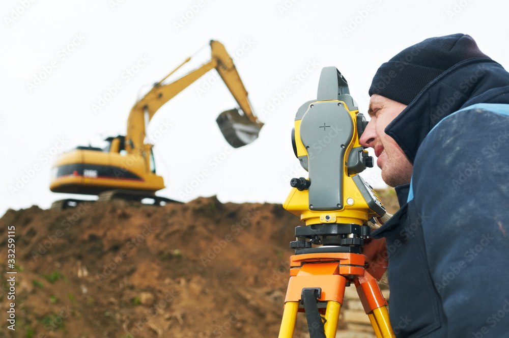 Obraz premium surveyor works with theodolite tacheometer