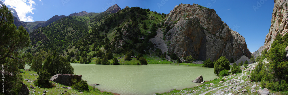 Fototapeta premium Mountain lake in background with high mountain
