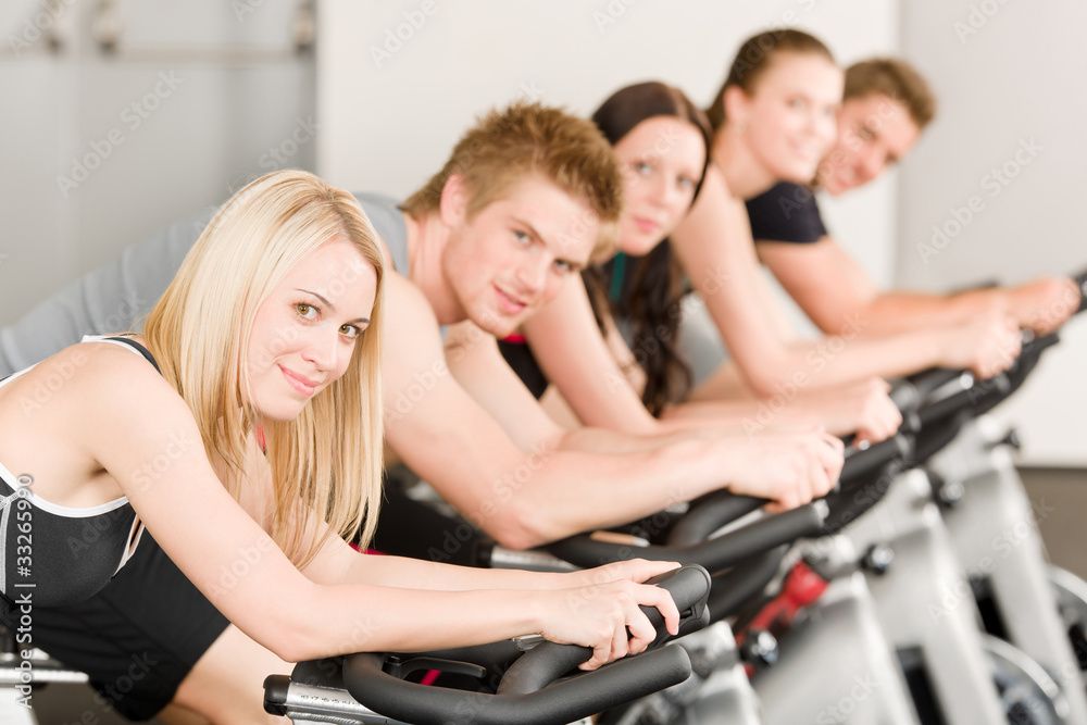 Fitness group of people on gym bike