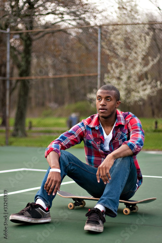 Skateboarding Guy Taking a Rest