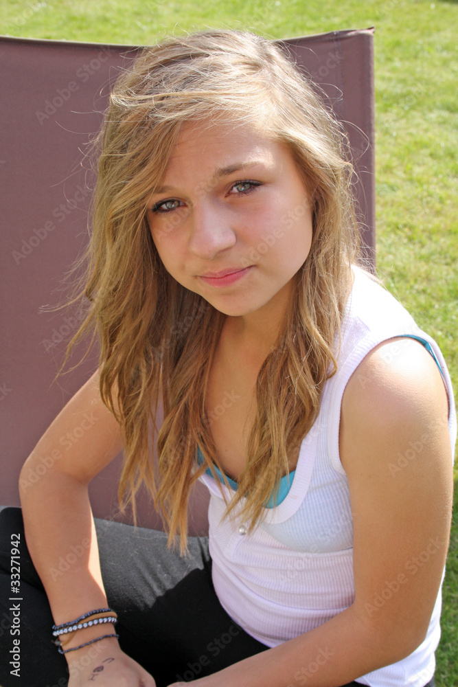 beautiful young girl sat on garden