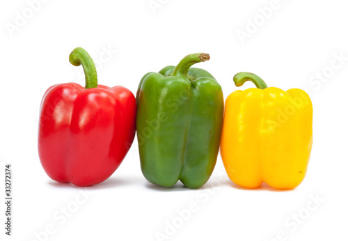 Three sweet peppers in yellow, red and green color