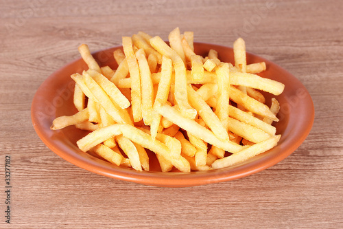 French fries on wooden background