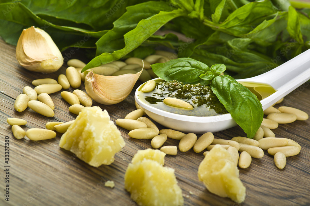 Pesto sauce over White spoon with fresh ingredients