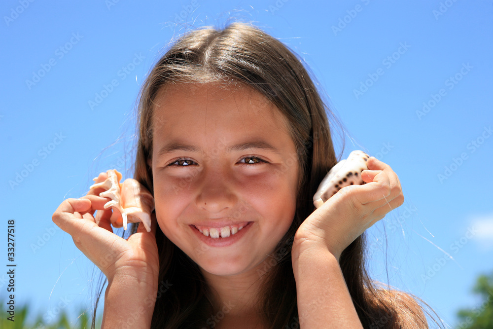 beautiful girl with shell at the beach in Summer vacation