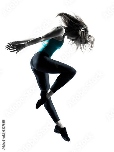 Flexible young female dancer jumping