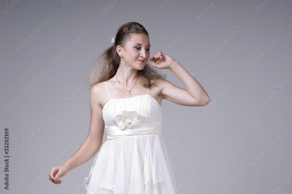 Naklejka premium Beautiful young woman in a white dress