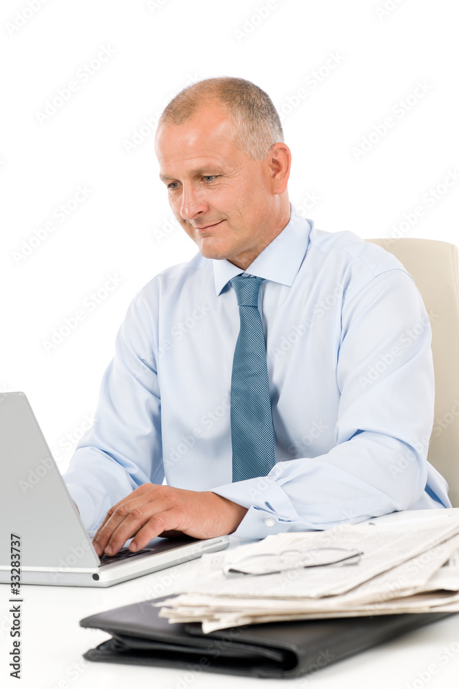 Happy businessman working in office behind desk Happy businessman working in office behind desk