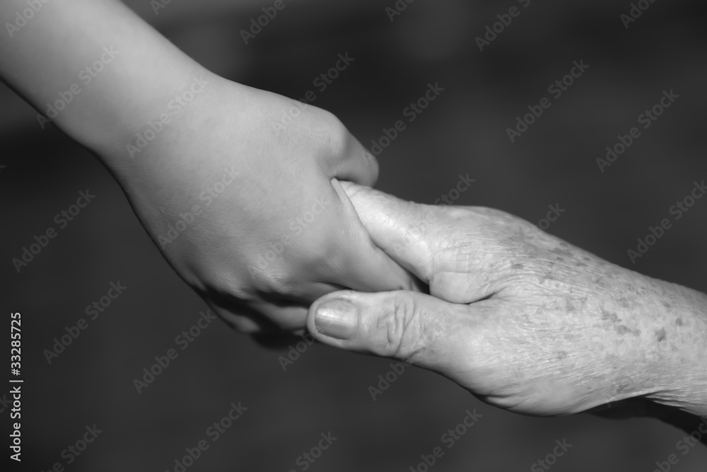 child holding old woman hand